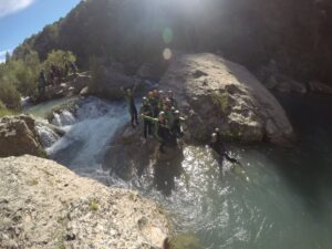 Grupo posando al lado de una cascada dentro del barranco del Ventano del Diablo en Cuenca